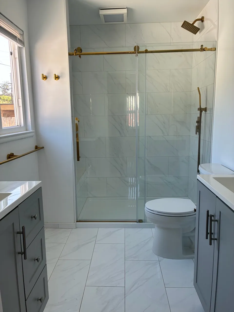 Bathroom with a glass shower and white tile
