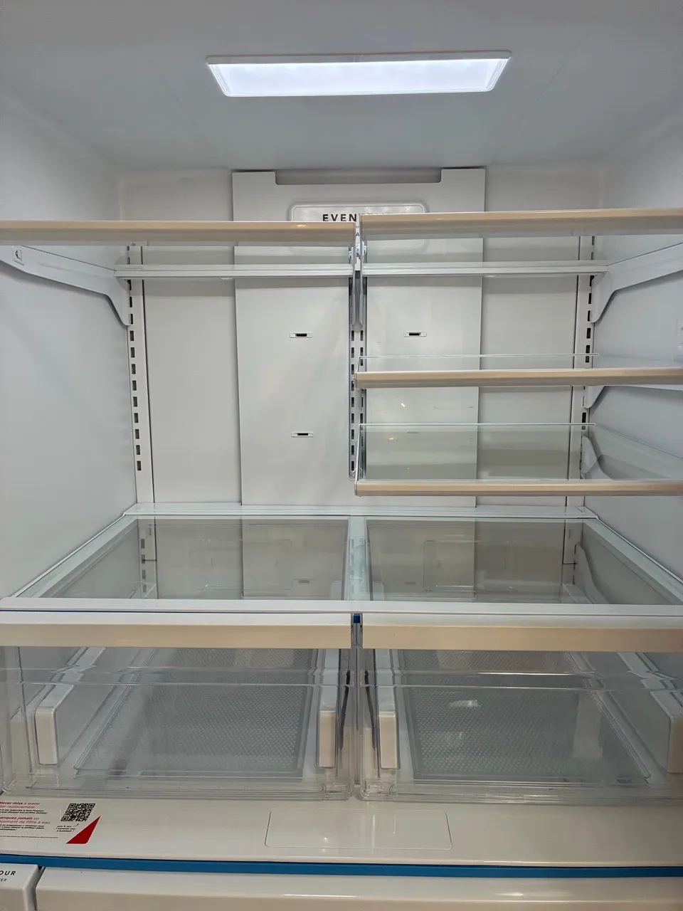 Walk-in closet with white shelving and hanging rails