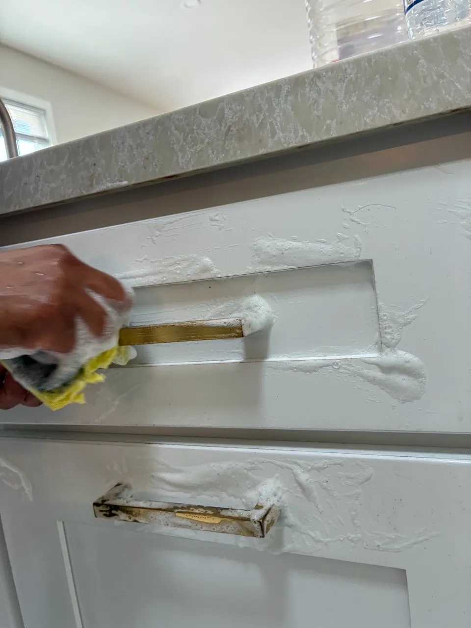Close-up of white cabinet drawer and trim